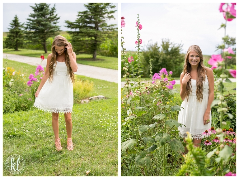 A high school senior in a white dress surrounded by flowers | Image by Kristina Lynn Photography & Design