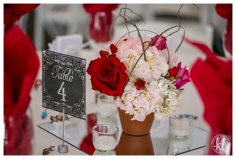 A beautiful wedding table centerpiece with red roses and pink flowers | Denver wedding photographer Kristina Lynn Photography & Design