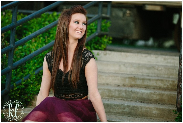 Senior girl sitting on stairs in an urban location.