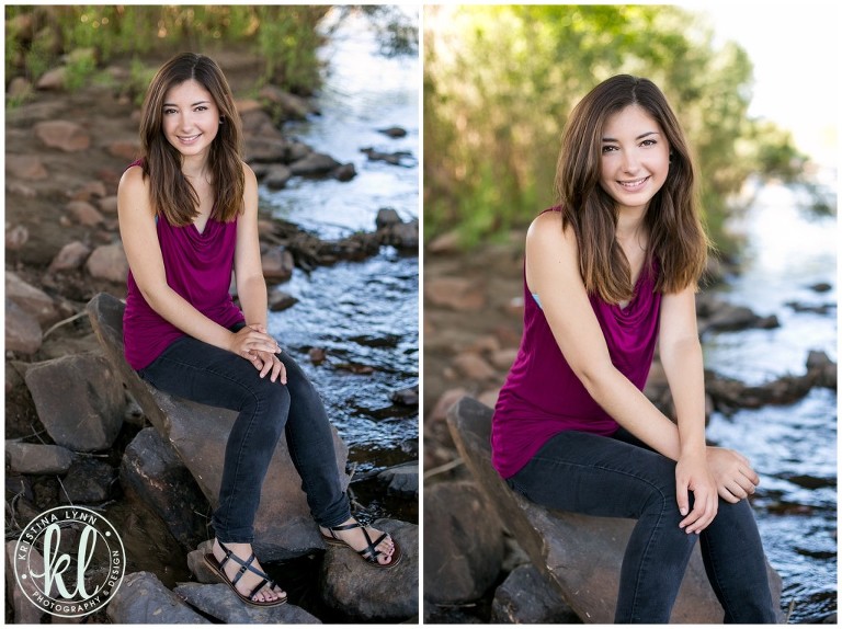 Casual photo of a high school senior sitting on a rocky shore by a river | Image by Kristina Lynn Photography & Design.