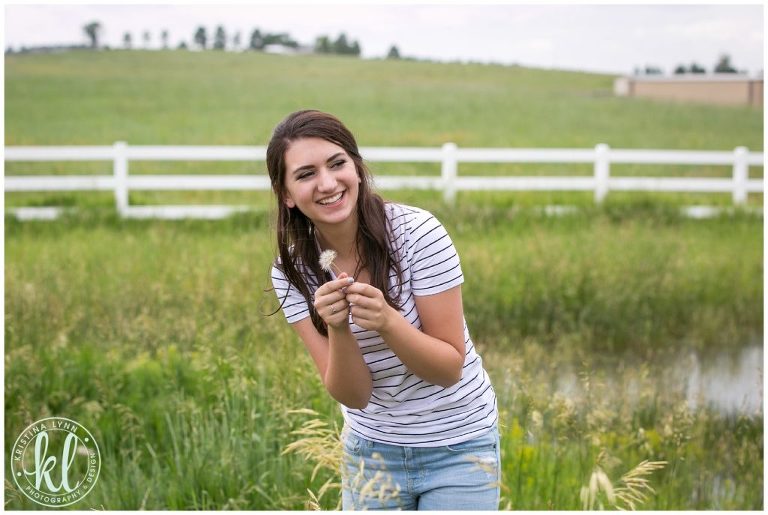 A candid photo of a teen girl during a senior photo session.