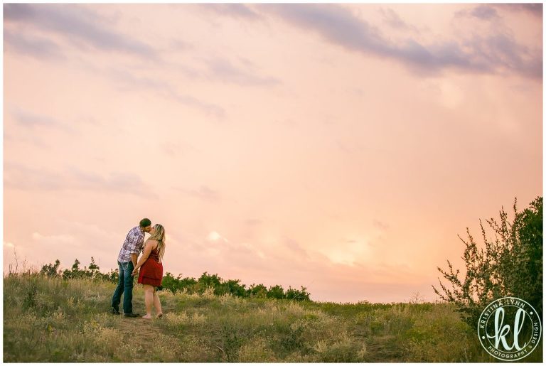 The sky filled with fiery pinks, oranges and reds at the end of this engagement session.