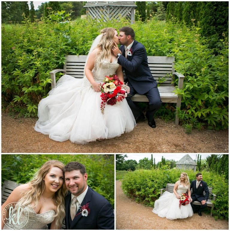 Wedding couple sits on a bench in a botanic garden in Iowa.