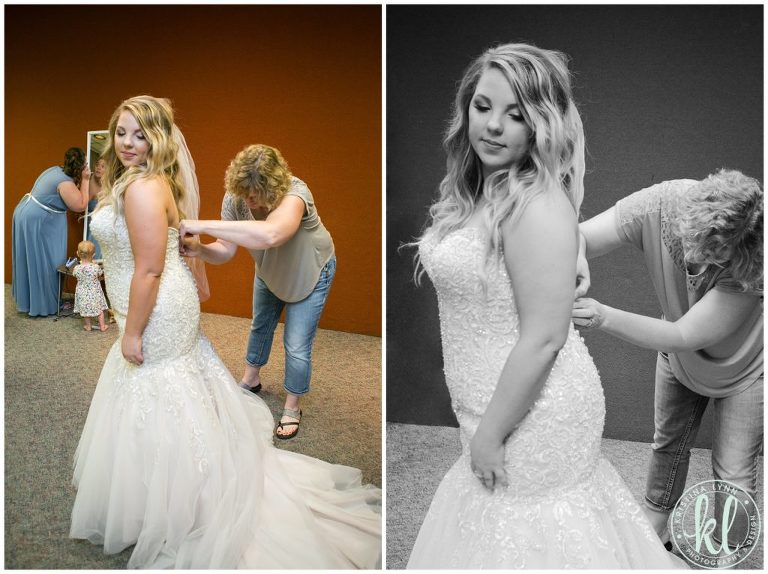 The bride's mom helps her into her dress on her wedding day.