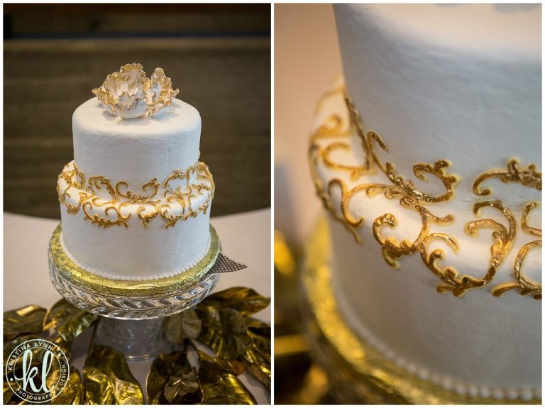 A two tiered wedding cake with gold accents.