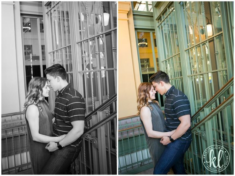 A guy and a girl snuggle together in a stairway with green patina metal.