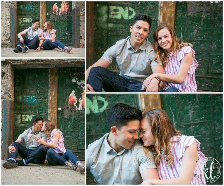 A pair cuddles in an urban alleyway during their photo shoot.