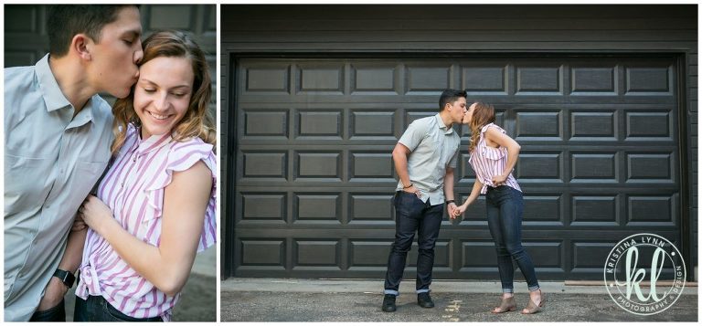 An engaged pair hold hands and kiss.