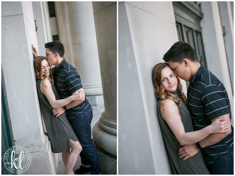 Engaged couple lean against stately columns during their engagement session in downtown St Paul.