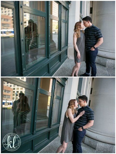Engaged couple laughing together in a modern urban setting.