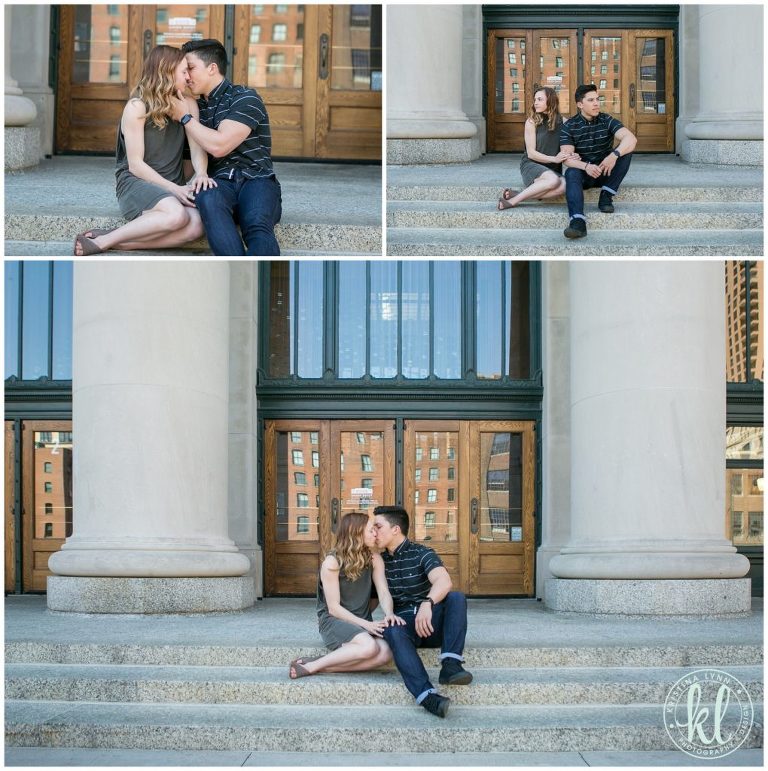 Engaged couple sitting in front of Union Depot in downtown Saint Paul, MN.