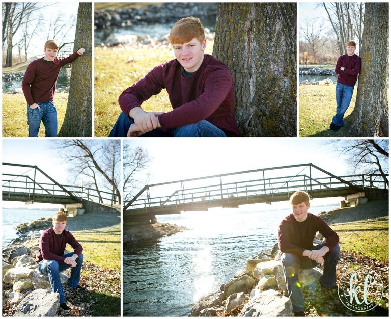 high school senior guy sitting on rocks on the bank of lake cornelia in clarion iowa