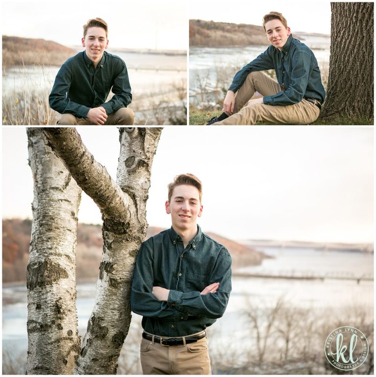 teen boy poses for senior pictures overlooking st croix river near stillwater minnesota