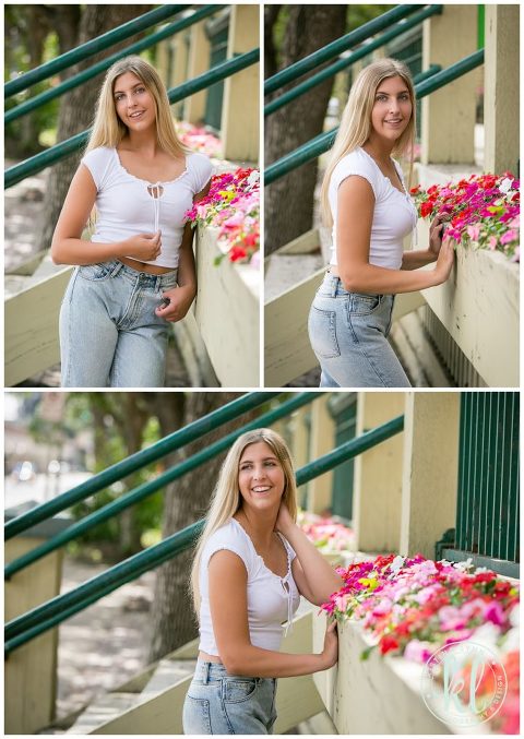 teenage girl standing near colorful flowers in downtown st paul for senior photos