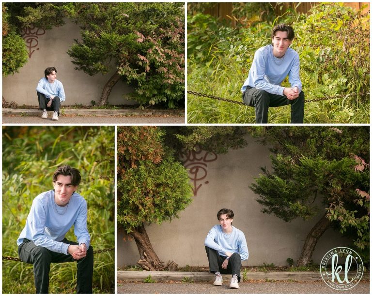 high school senior guy posing for pictures in downtown stillwater minnesota