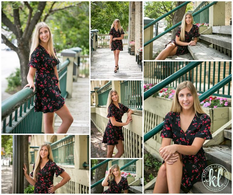 teenage girl in a black dress poses for senior photos outside city building in downtown st paul minnesota