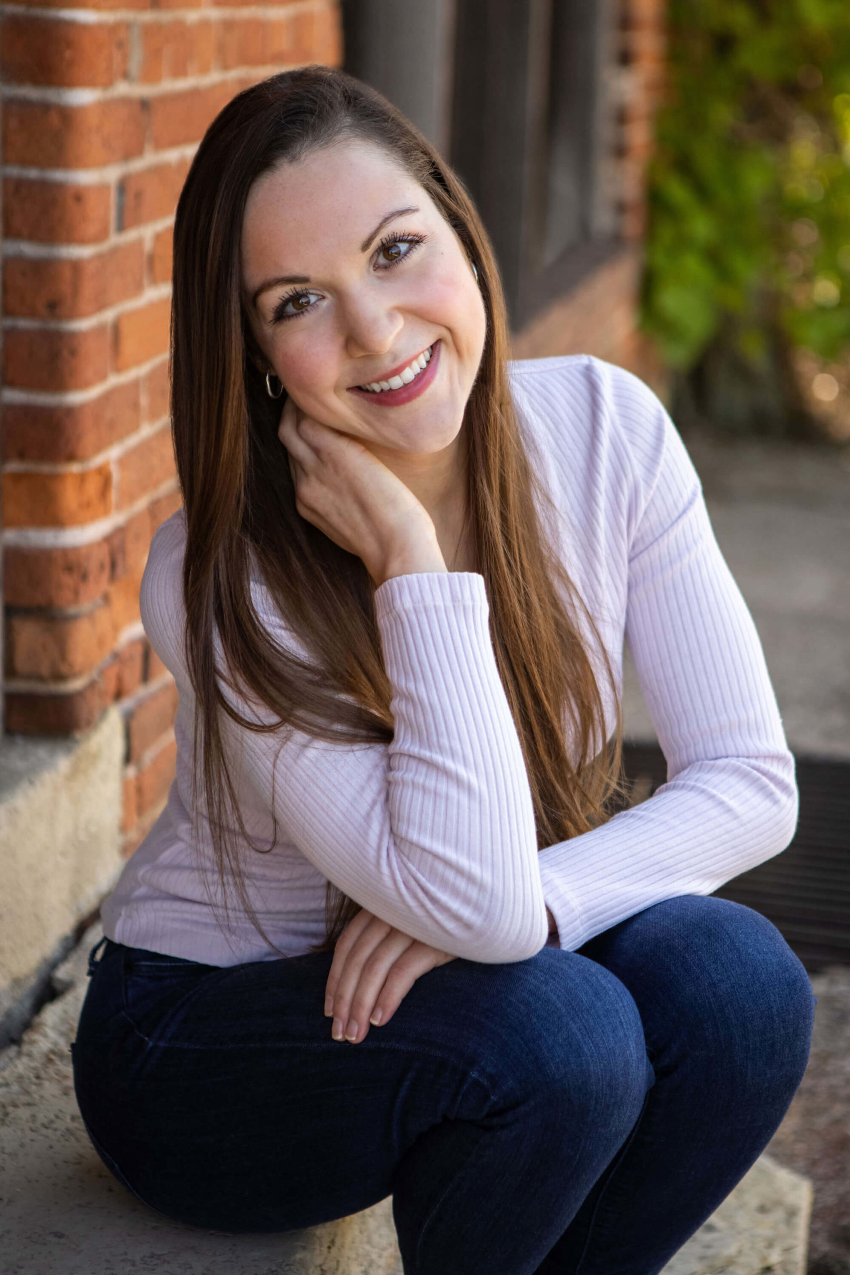 Kristina Lynn Photo of woman posing casually in urban setting stairs for unique business headshot.