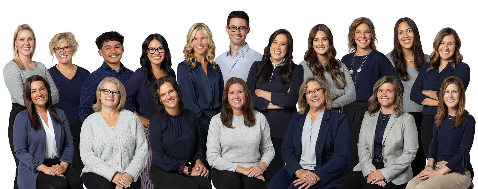 A businesses professional group photo. They group wears a palette of navy blues and grey.